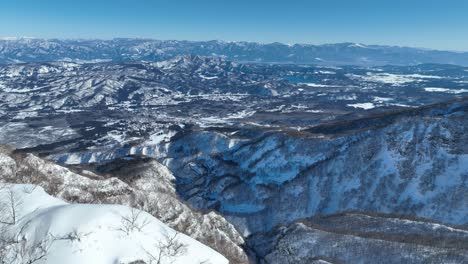 aerial shot of japan's mount myōkō valley, massive height of mountains revealed