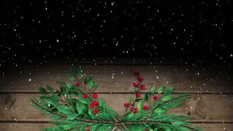 Animation-of-christmas-holly-and-fir-tree-branches-decoration-over-snow-falling-wooden-background