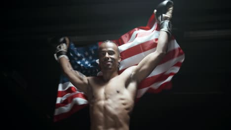 strobed slow motion video of a boxer proudly showing the american flag after he won a hard boxing fight for his country