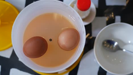 Top-view-of-half-boiled-egg,-in-a-bowl-on-table-,