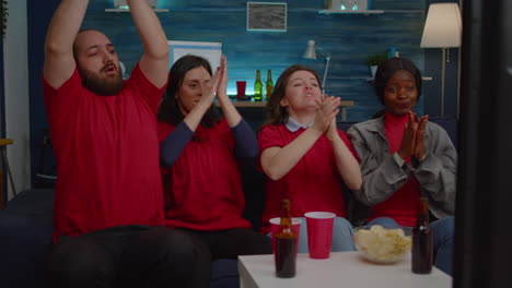 Multiracial-group-of-friends-cheering-football-team-during-soccer-competition