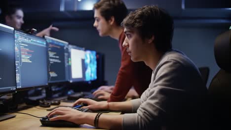 intense collaboration in coding: a group of young programmers engaged in application development and troubleshooting in a high-tech workspace