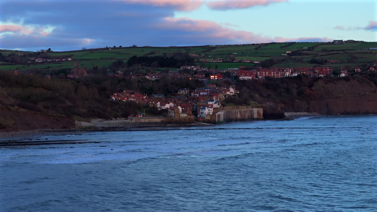 Low Wide Angle Establishing Drone Shot of Robin Hood's Bay Yorkshire