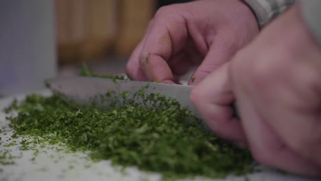 Close-up-slow-motion-on-knife-cutting-parsley-in-Montpellier-market-Hall-Laissac