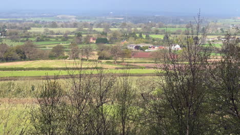 A-view-over-the-lush-countryside-in-Worcestershire,-England-on-a-windy-sunny-spring-day