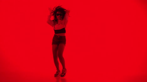 dynamic woman dancing in red light