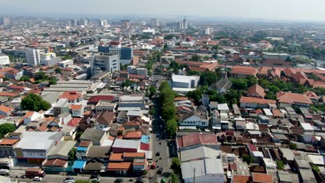 Street-traffic-and-living-suburbs-of-Semarang-city,-Central-Java,-Indonesia,-aerial-view