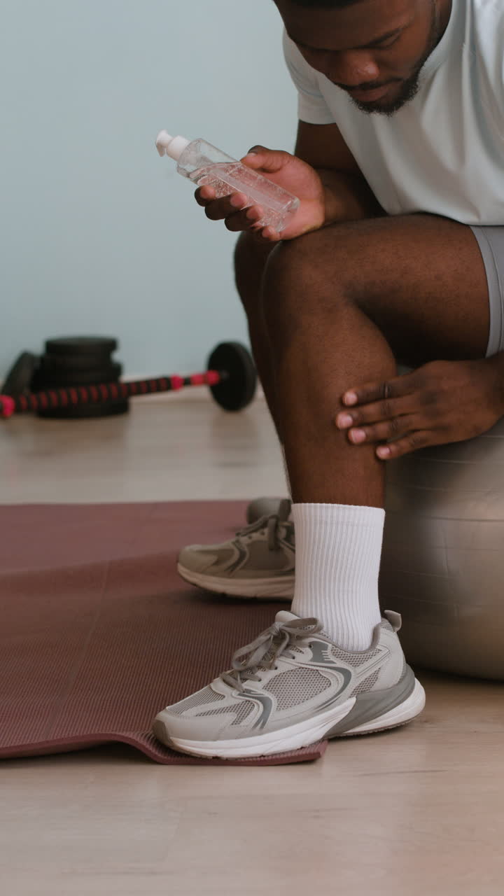 Man using hand sanitizer after a workout