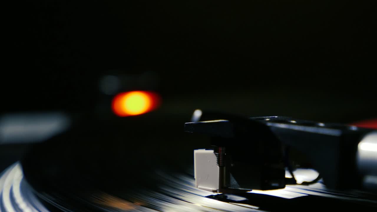 Closeup needle on spinning vintage vinyl record on turntable