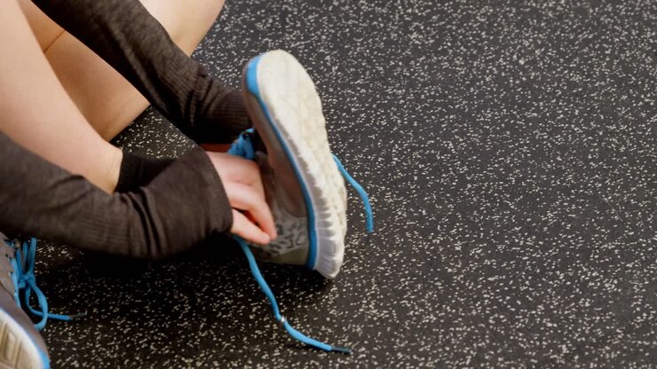Woman wearing shoe in a fitness studio 4k
