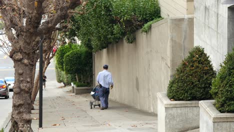 post man delivering mail on steep hill