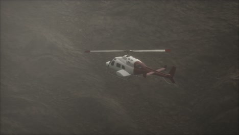 extreme slow motion flying helicopter near mountains with fog