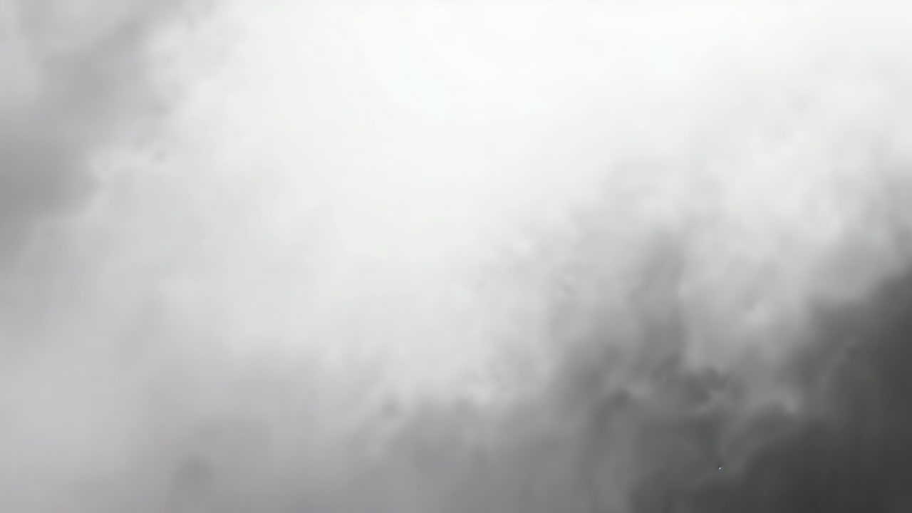 Darker mass appearing sparking dense smoke plume growing in open sky, with density rising