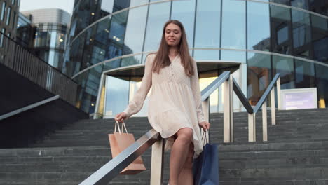 woman sliding down handrail after shopping