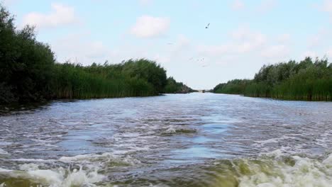 traveling by boat over the waters of danube delta -wide