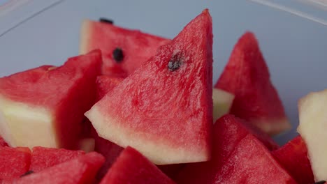 metal fork stabbing a juicy red watermelon, close-up shot.
