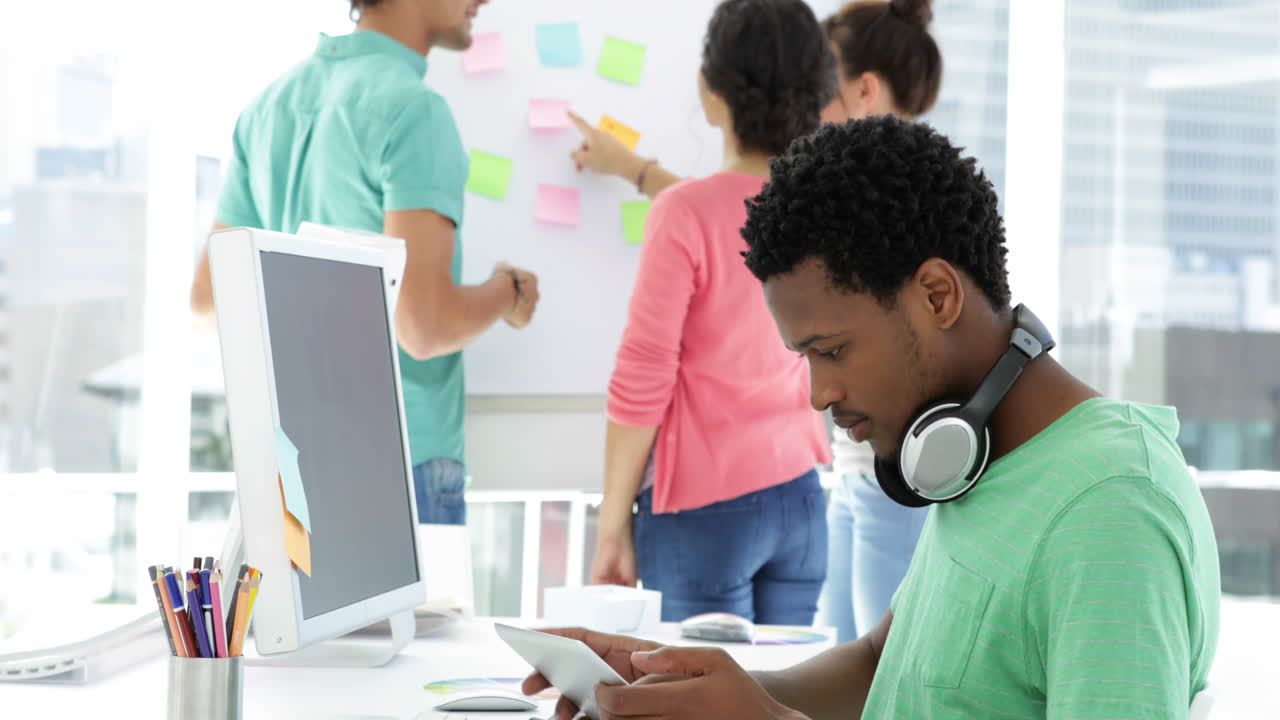 Attentively working creative designer using his tablet 