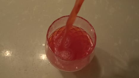 Overhead-shot-of-red-liquid-being-poured-into-wine-glass