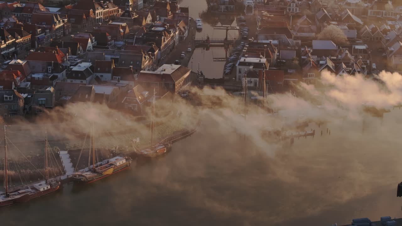 Aerial telephoto shot of Makkum town Friesland during winter morning