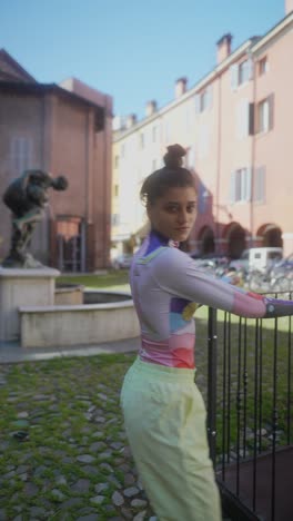 stylish woman dancing in a city square