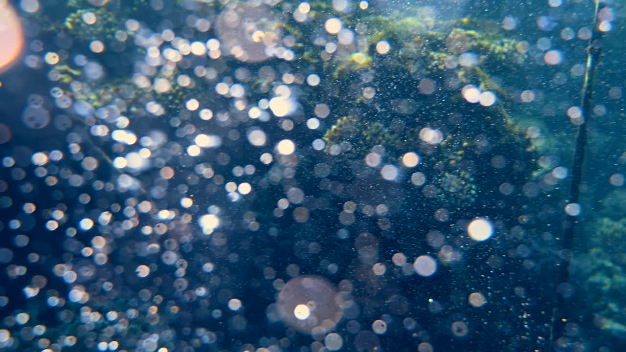 Underwater view of the waves and the bubbles of the red sea