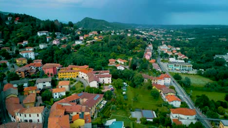 4k aerial drone video of mountainside farmhouses in cavallasca, italy on a summer evening