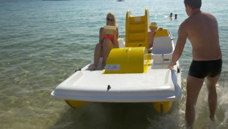 Family-is-going-to-have-exciting-water-ride-on-pedal-boat