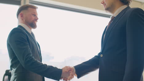 two businessmen talking and shaking hands