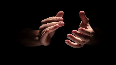 hands clapping on black background close up