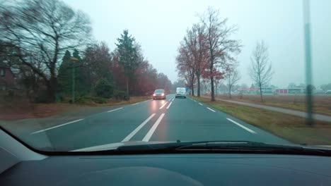 driving trough the dutch countryside in my car during autumn