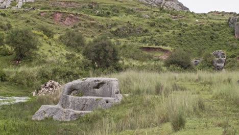 Carved-rock-next-to-creek-in-Cusco,-Peru-4k-50fps