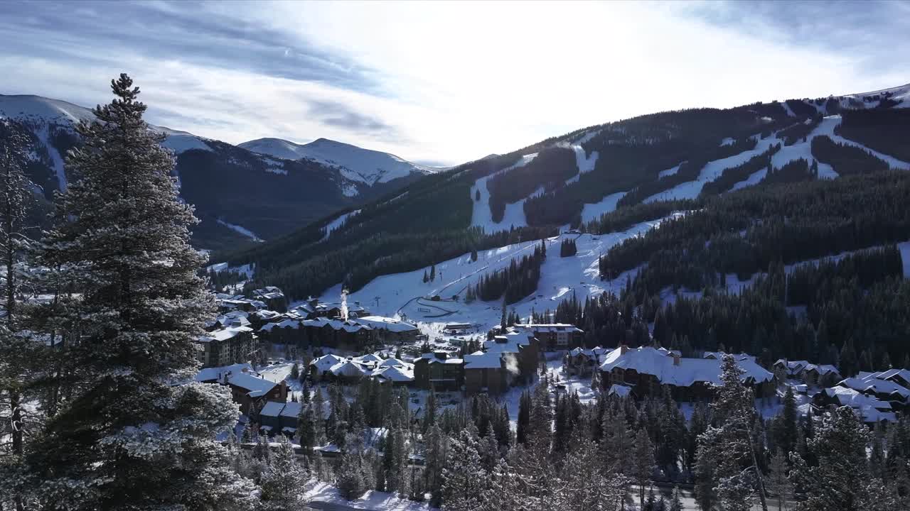 Copper Mountain Ski Resort aerial drone view chairlifts gondola halfpipe center village Ikon Pass Alterra snowboarding snow skiing riding trails morning winter solstice December trees upward motion
