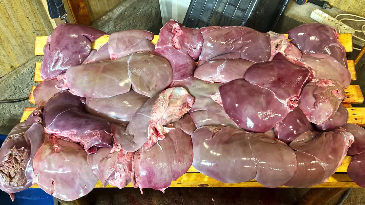 Set of shiny raw animal livers on a a table. Zoom in
