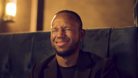 professional male talking to camera waves, smiles and laughs on a videocall