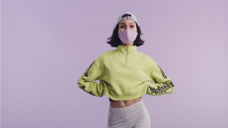 a-stylish-young-woman-wearing-a-mask-while-posing