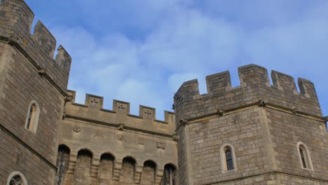 looking up at windsor castle on sunny day as aeroplane flies by