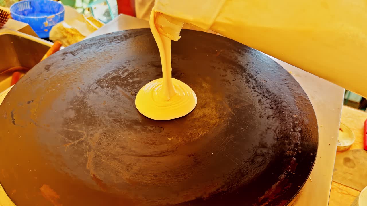Making crepes on a hot griddle in a Sharm El Sheikh street market