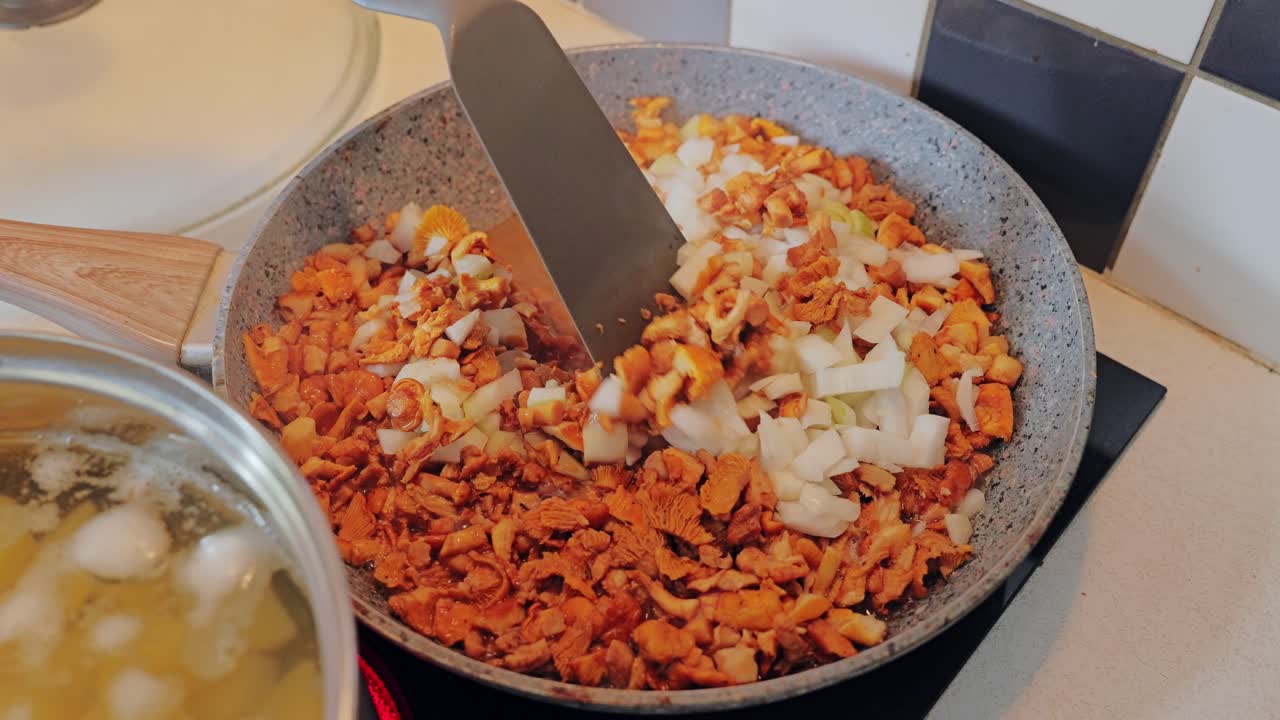 Minimalist kitchen interior, local woman prepares simple mushroom potato meal