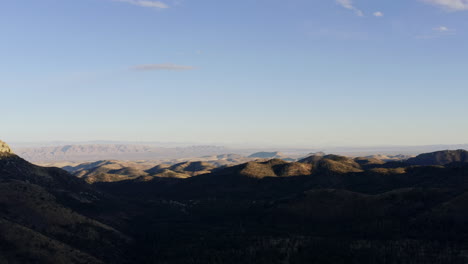 slowly descending aerial view of rolling hills into desert landscape, 4k