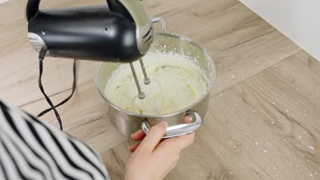 clip of cream being mixed in a bowl as part of tiramisu dessert making
