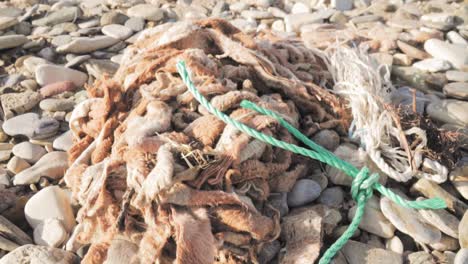 discarded fishing net and rope on a beach