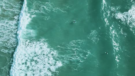 A-group-of-surfers-trying-to-navigate-their-way-through-choppy-waters