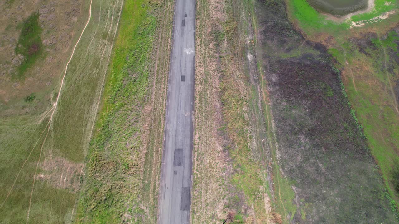 Zenith shot tilt up reveal tropical floodplain with wetlands and pools, green. Green tropical flatland