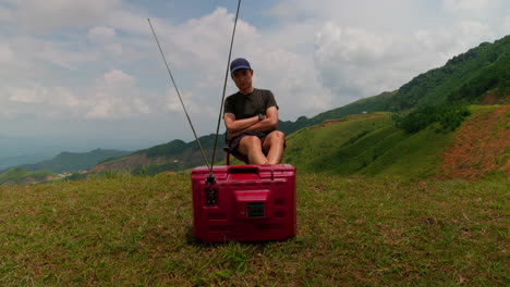 abstract male watching old crt tv in nature with mountain backdrop