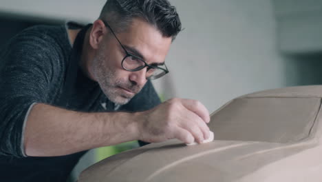 car designer working on a clay model