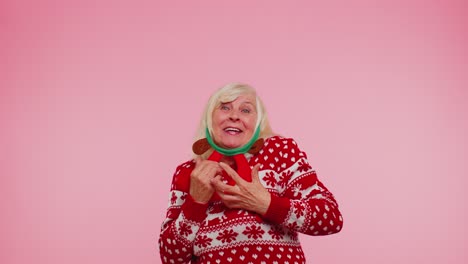Crazy senior elderly grandmother woman demonstrating tongue out fooling around making silly faces
