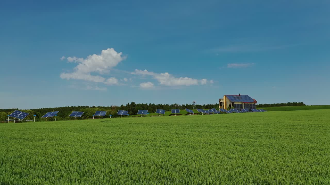Green agricultural field. Photovoltaic sunny batteries among nature. Solar cells collect ecological energy in bright sunny day. Drone view.