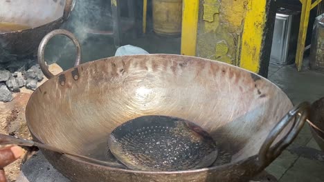 High-angle-shot-over-luchis-or-Indian-Poori-which-is-a-deep-fried-bread-made-from-flour-in-an-roadside-stall-in-India