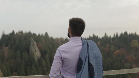 young man on the hill of a mountain with jacket. businessman. bridegroom. groom