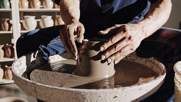 Potter Shaping Clay on a Spinning Pottery Wheel